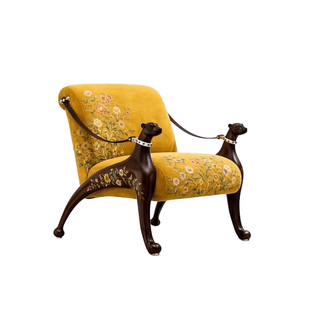 A vintage-style armchair with mustard yellow floral upholstery and dark brown carved dog-shaped arms connected by a harness, shown on a plain white background.