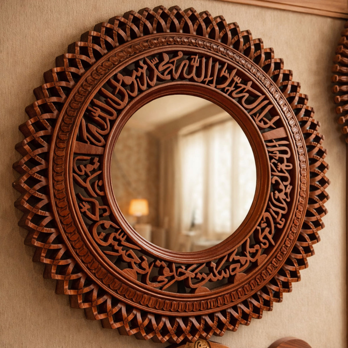 Decorative round mirror with intricate carvings on a beige wall